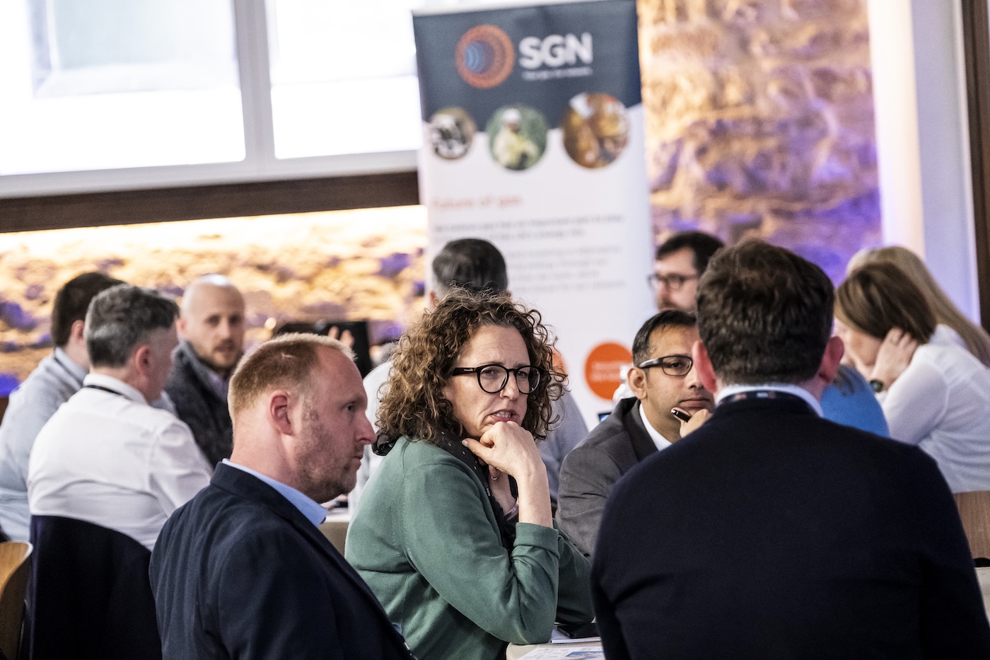 Attendees at the SGN spring workshops sitting around a table in discussion during the event in Edinburgh.